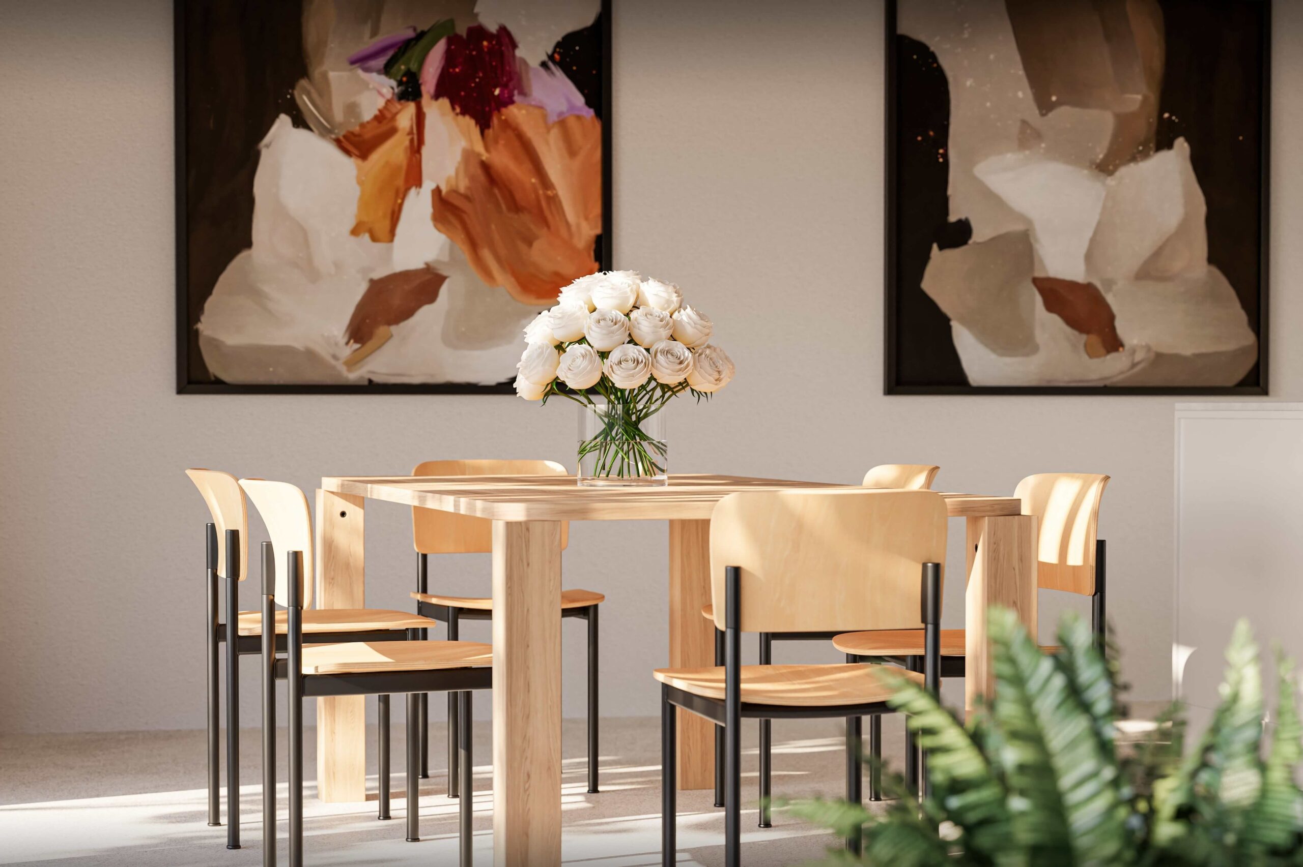 Detailaufnahme des Essbereichs im Projekt Biel-Benken Panorama der Ernst Frey AG. Ein heller Holztisch mit minimalistischen Stühlen steht im Mittelpunkt des Raumes, geschmückt mit einem Blumenstrauß aus weißen Rosen. Moderne Kunstwerke an der Wand und sanftes Tageslicht schaffen eine stilvolle, einladende Atmosphäre.